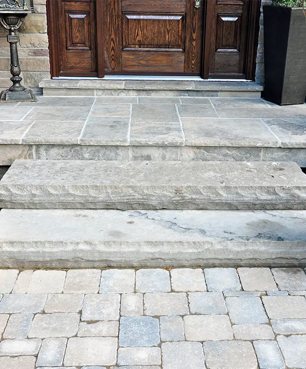 A paver patio in front of a door