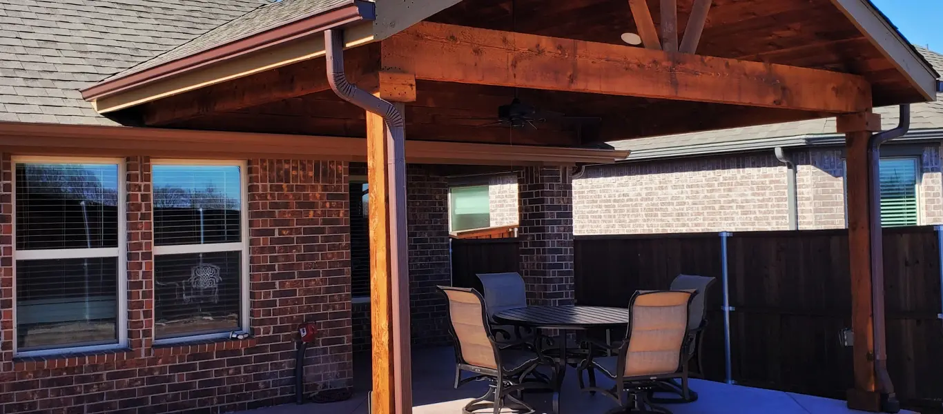 A covered patio with cedar roof and pavers