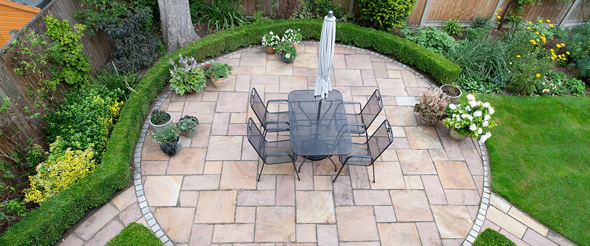 circular garden patio with freshly jet washed paving stones