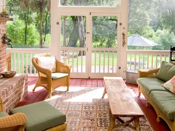 A sunroom with redwood decking and a fireplace